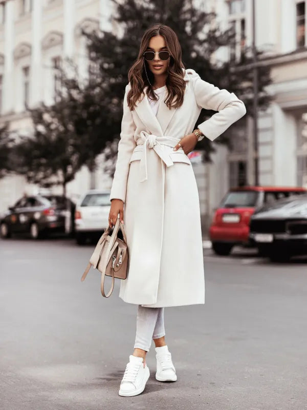 Women's long belted winter coat with attached hood, cozy lining, city-chic silhouette for cold weather