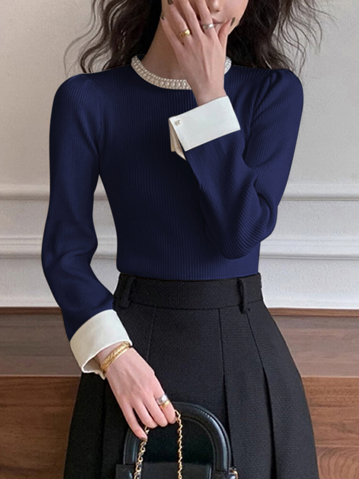 Women's slim knit sweater with pearl detail accents and elegant contrast trim finishing