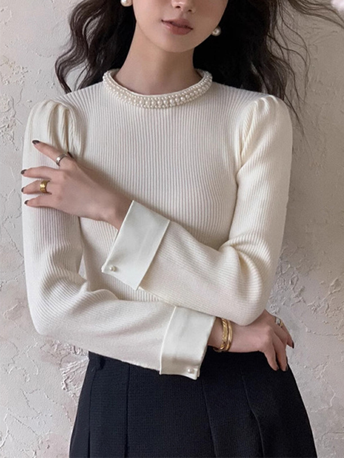 Women's slim knit sweater with pearl detail accents and elegant contrast trim finish