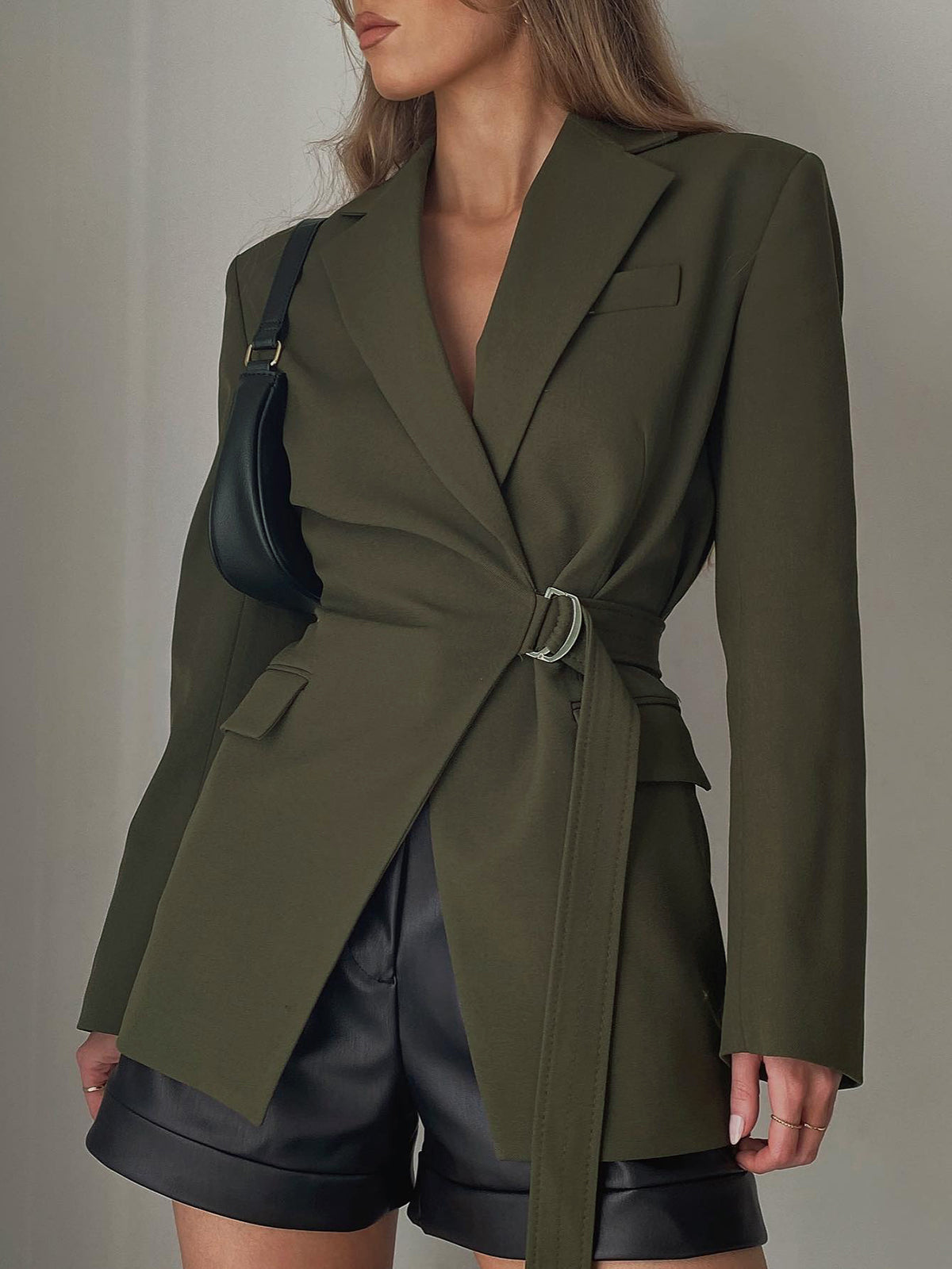 Women's black stretchy formal blazer with broad structured shoulders and slim sleeves