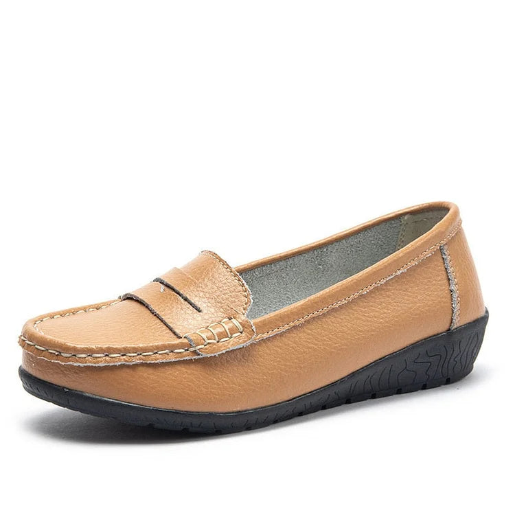 Women's black leather slip-on loafers with cushioned PU lining and flexible rubber sole for all-day comfort