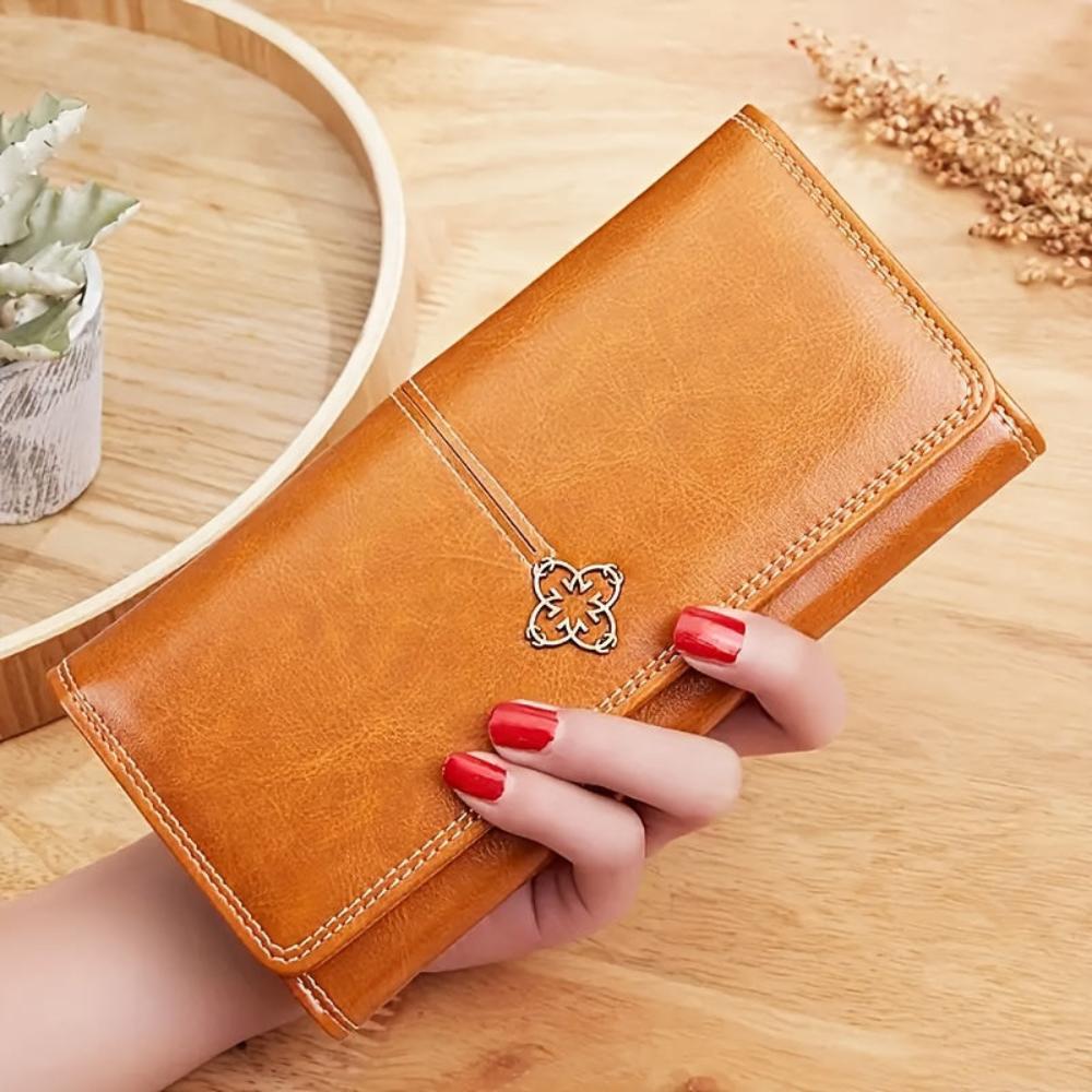 Men's black vegan leather bifold wallet with contrast stitching and decorative metal emblem