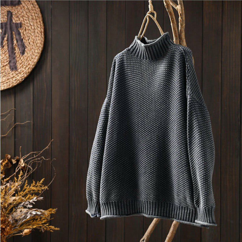 Cream waffle-knit turtleneck sweater with dropped shoulders and structured relaxed fit