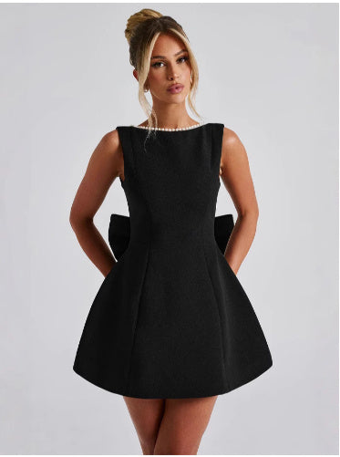 White flared cocktail mini dress with pearl accents, elegant sleeveless silhouette for special occasions