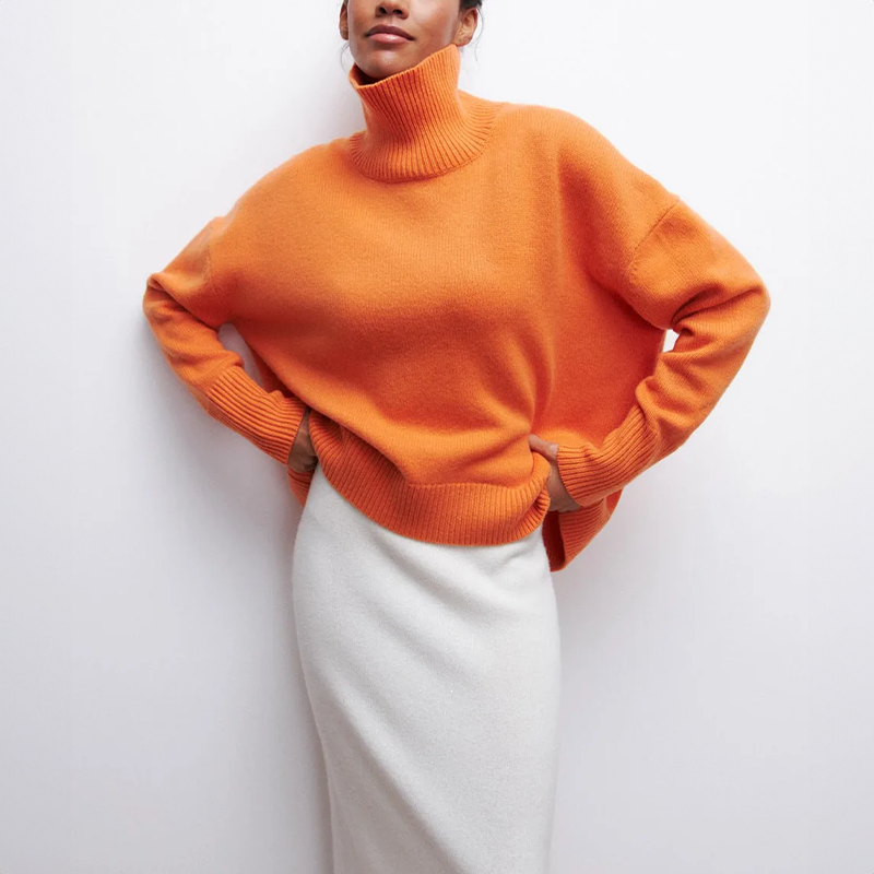 Women's oversized turtleneck knit sweater with draped silhouette and ribbed cuffs for layering