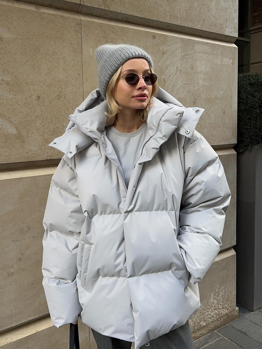 Women's oversized black hooded winter jacket with padded silhouette for cozy urban street style