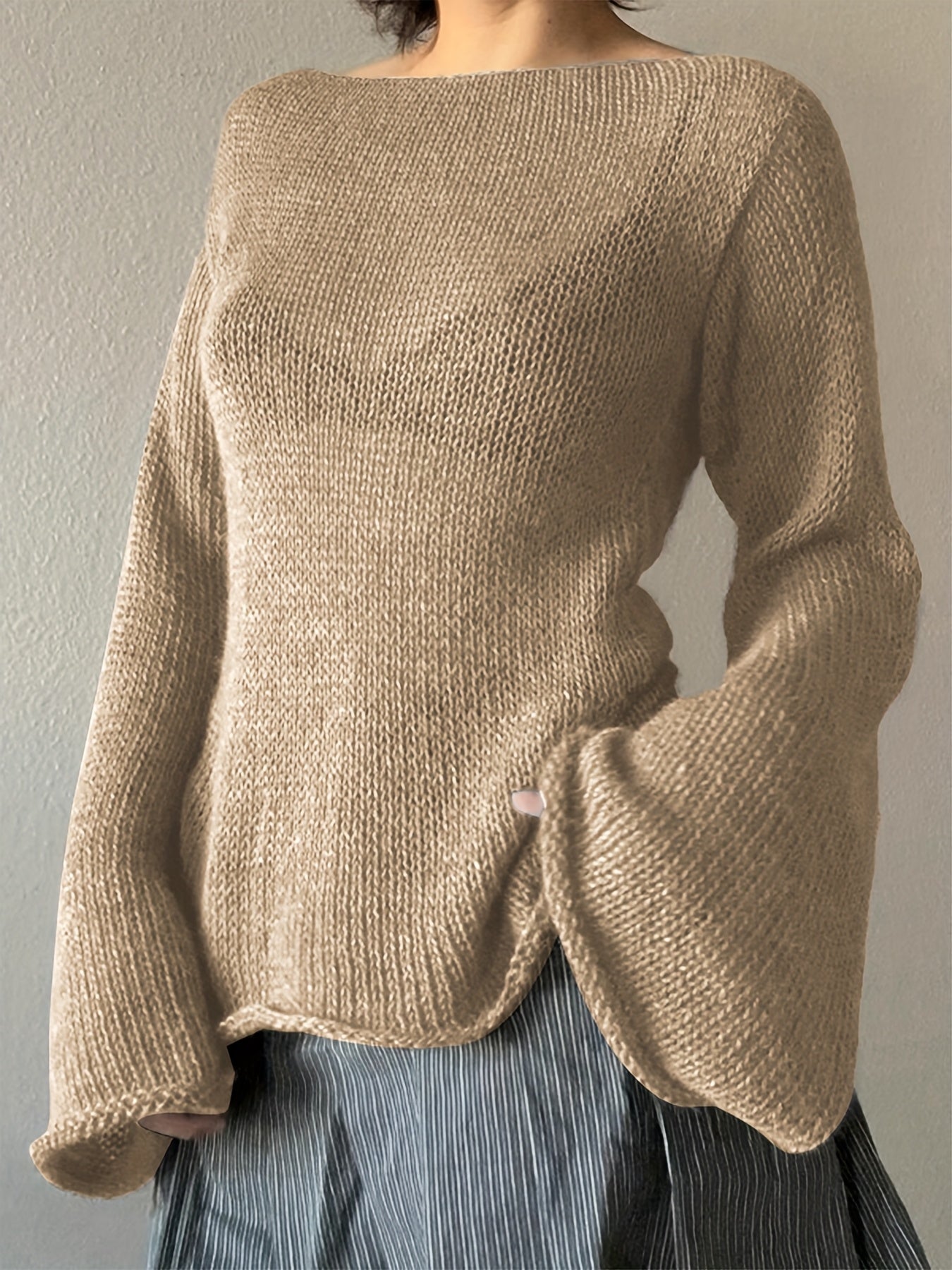 Women's minimalist knit sweater with elegant flared draped sleeves in a clean streamlined silhouette