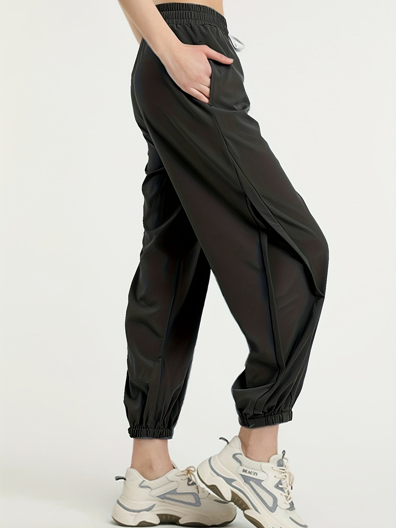 Black tapered performance jogger with breathable mesh side panels, ultra-light quick-dry fabric