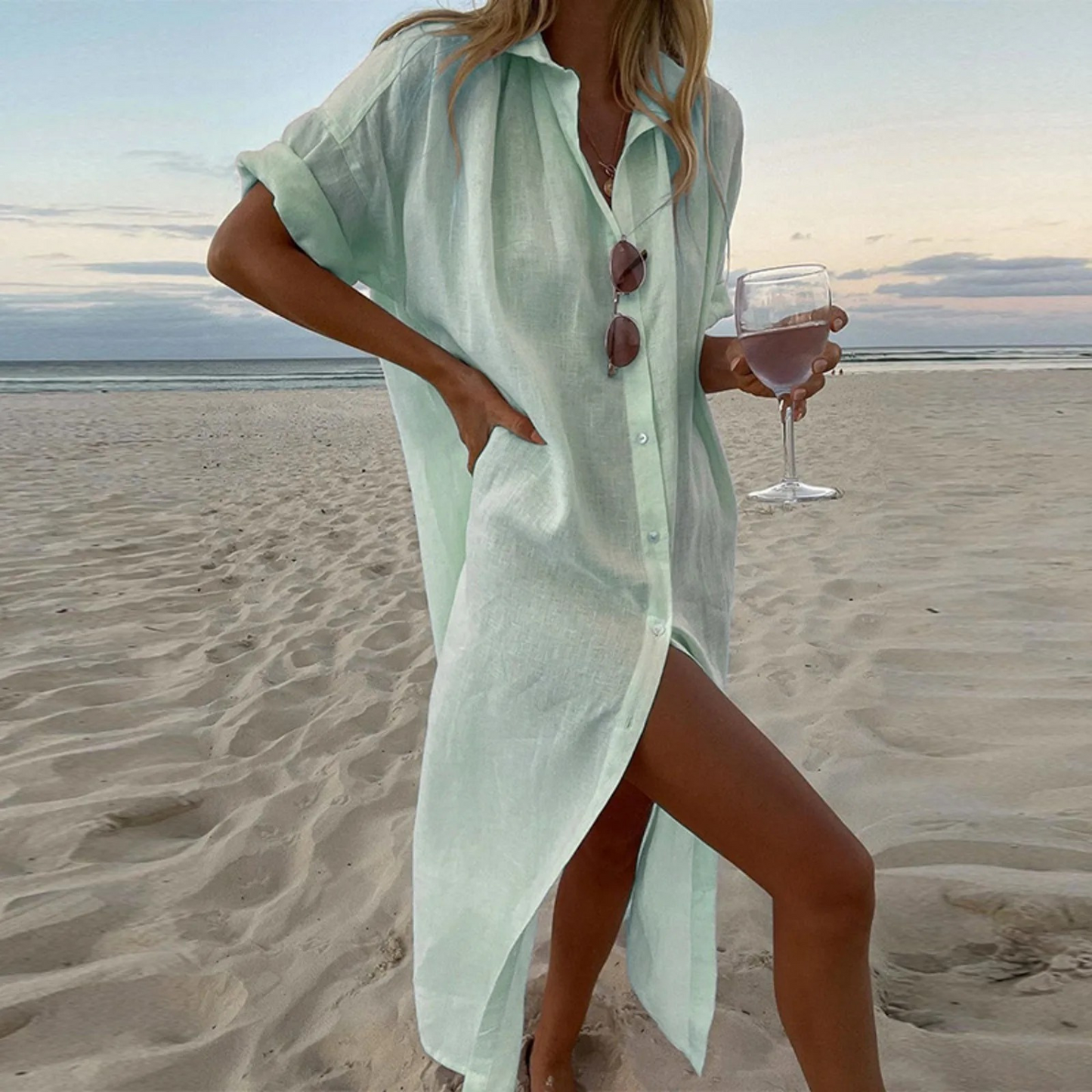 Elegant white shirt dress with high slits, button-front detail, and refined modern silhouette