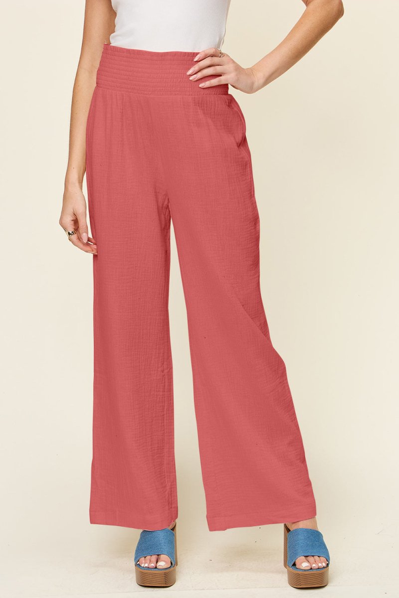 Plus size black wide leg pants with smocked elastic waist and distinctive textured finish for all-day comfort