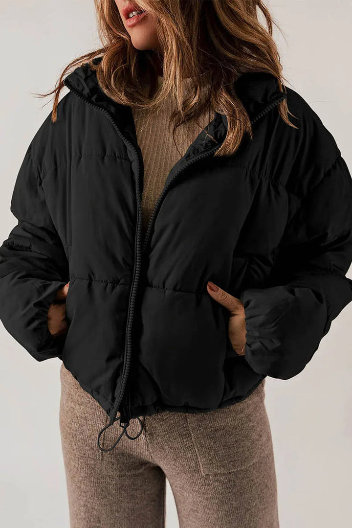 Women's lightweight quilted puffer jacket with adjustable hood and pockets for everyday warmth