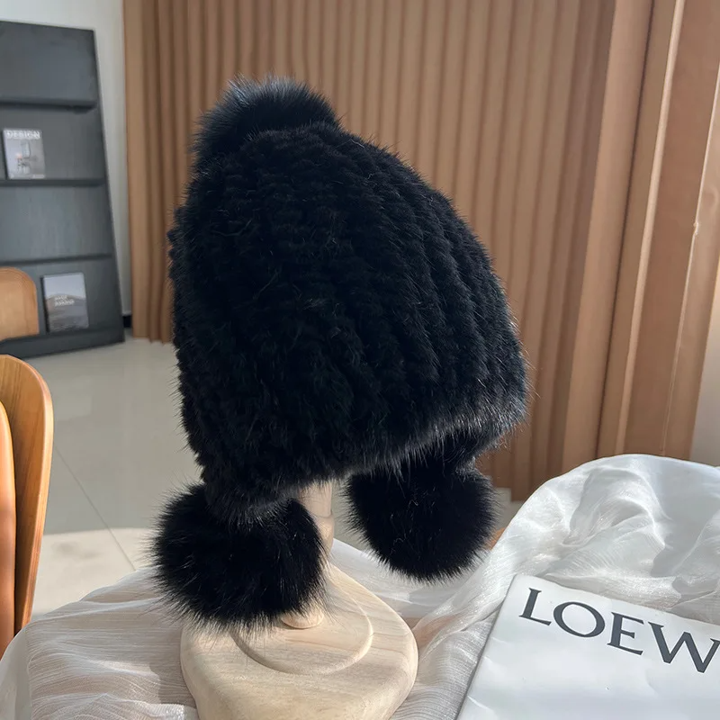 Women's warm ribbed knit fur beanie in neutral tones with playful plush pom poms for winter style