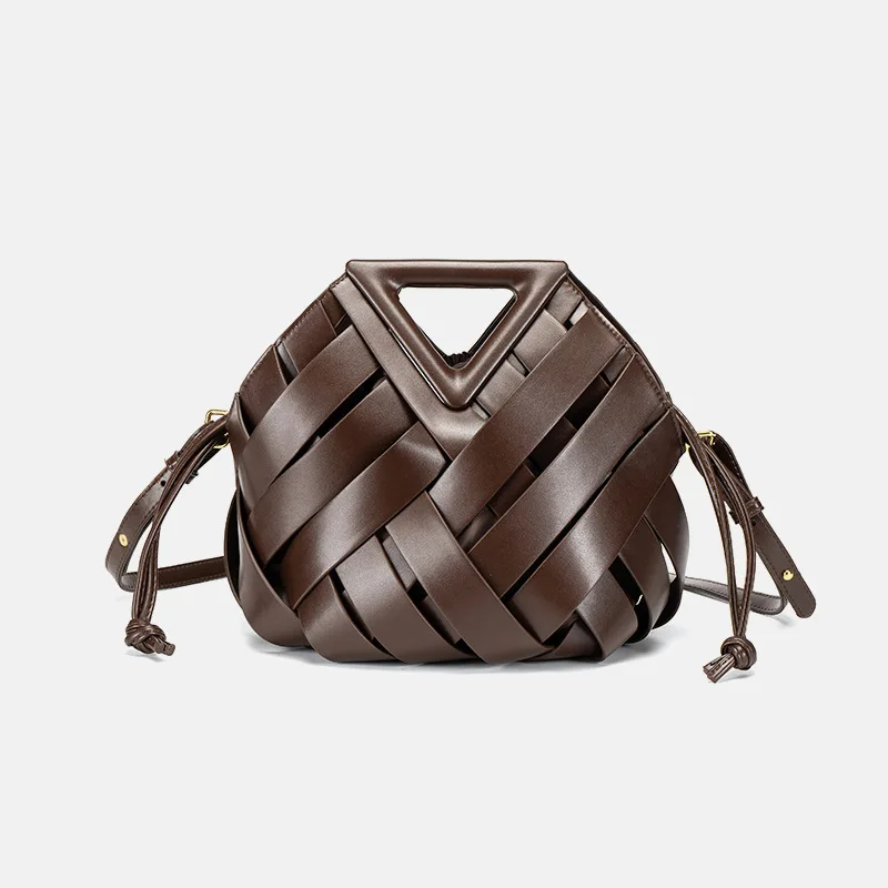 Woven leather bucket bag with geometric top handle and drawstring pouch for modern professionals