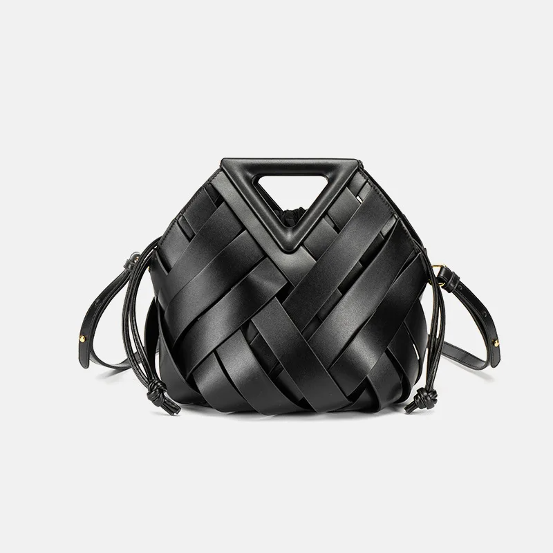 Tan handwoven leather bucket bag with geometric top handle and drawstring pouch for modern professionals