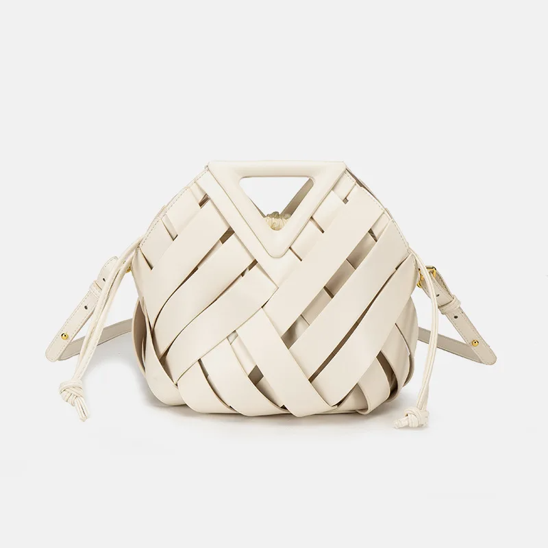 Woven leather bucket bag with geometric top handle and drawstring pouch for modern professionals