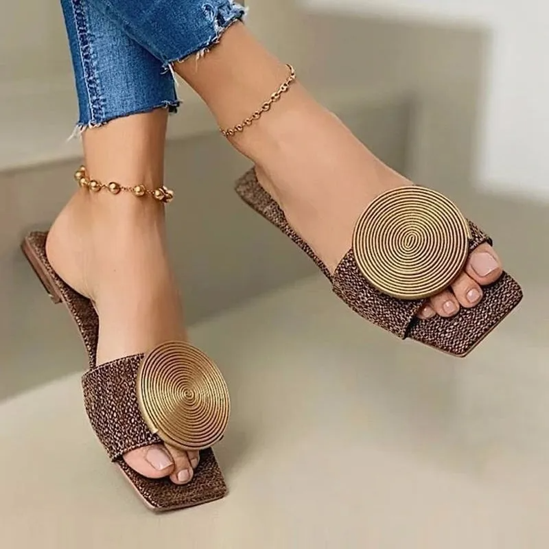 Women's slip-on slide sandal with bold textured medallion detail, lightweight flexible comfort design