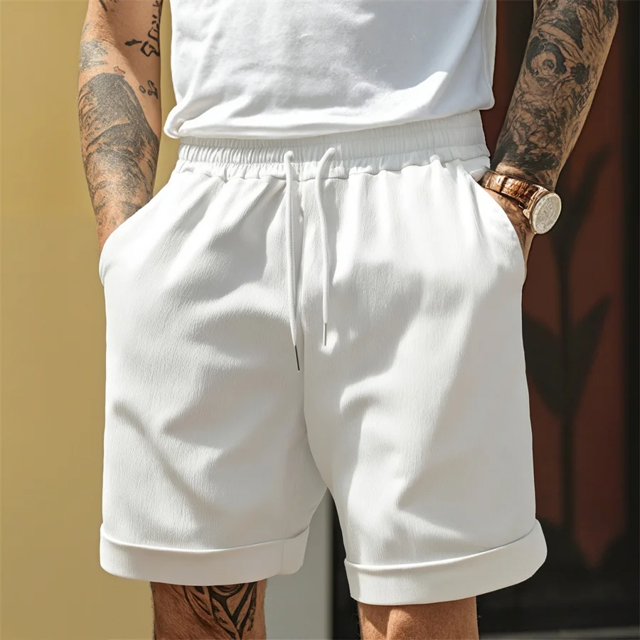 Men's light beige cuffed shorts lightweight textured fabric tapered silhouette elastic waistband drawstring