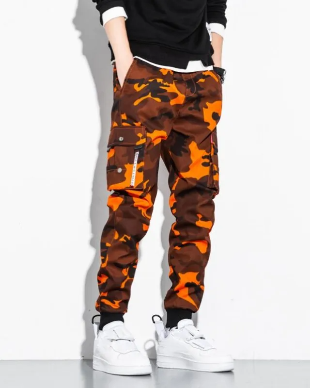 Delta camo tapered cargo jogger pants with aggressive print and stacked utility pockets for streetwear
