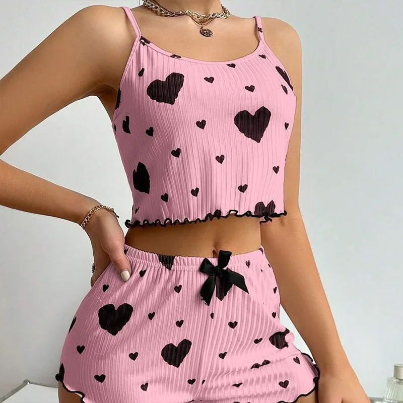 Women's ribbed two-piece pajama set with cropped cami, ruffled hems, and vibrant heart prints
