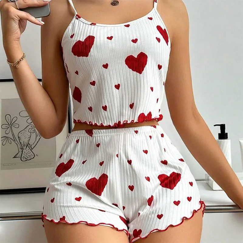 Women's ribbed two-piece pajama set with cropped cami, heart prints, and ruffled hems