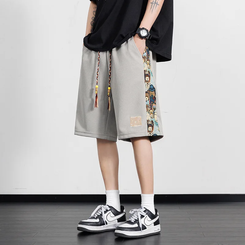 Black streetwear shorts with bold panel design, teddy bear embroidery, and oversized drawstrings in breathable cotton