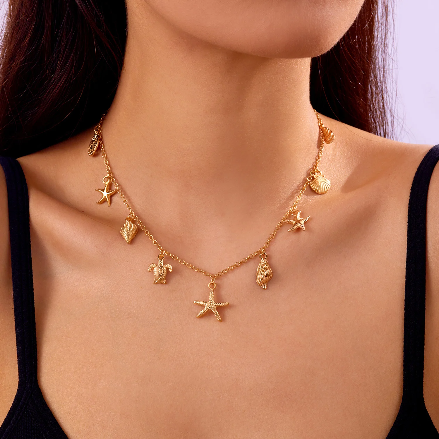 Sirene gold-tone adjustable charm necklace with shells, stars, and pearls for coastal layering