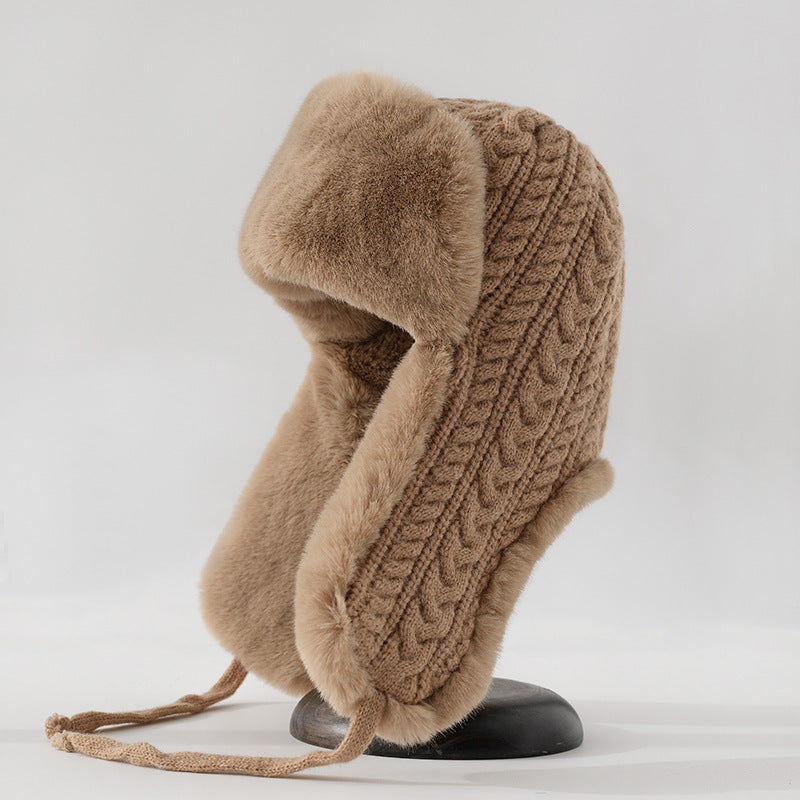 Cream cable knit trapper hat with faux fur trim ear flaps and braided tie straps for women