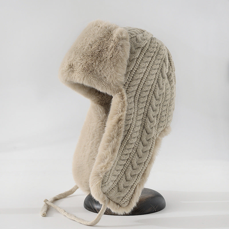 Cream cable knit trapper hat with faux fur trim ear flaps and braided tie straps for women