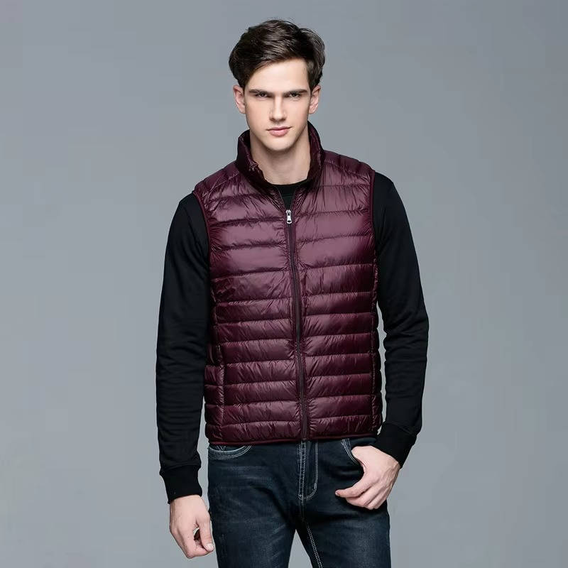 Men's lightweight navy packable down vest with slim fit and zippered chest pocket for travel warmth