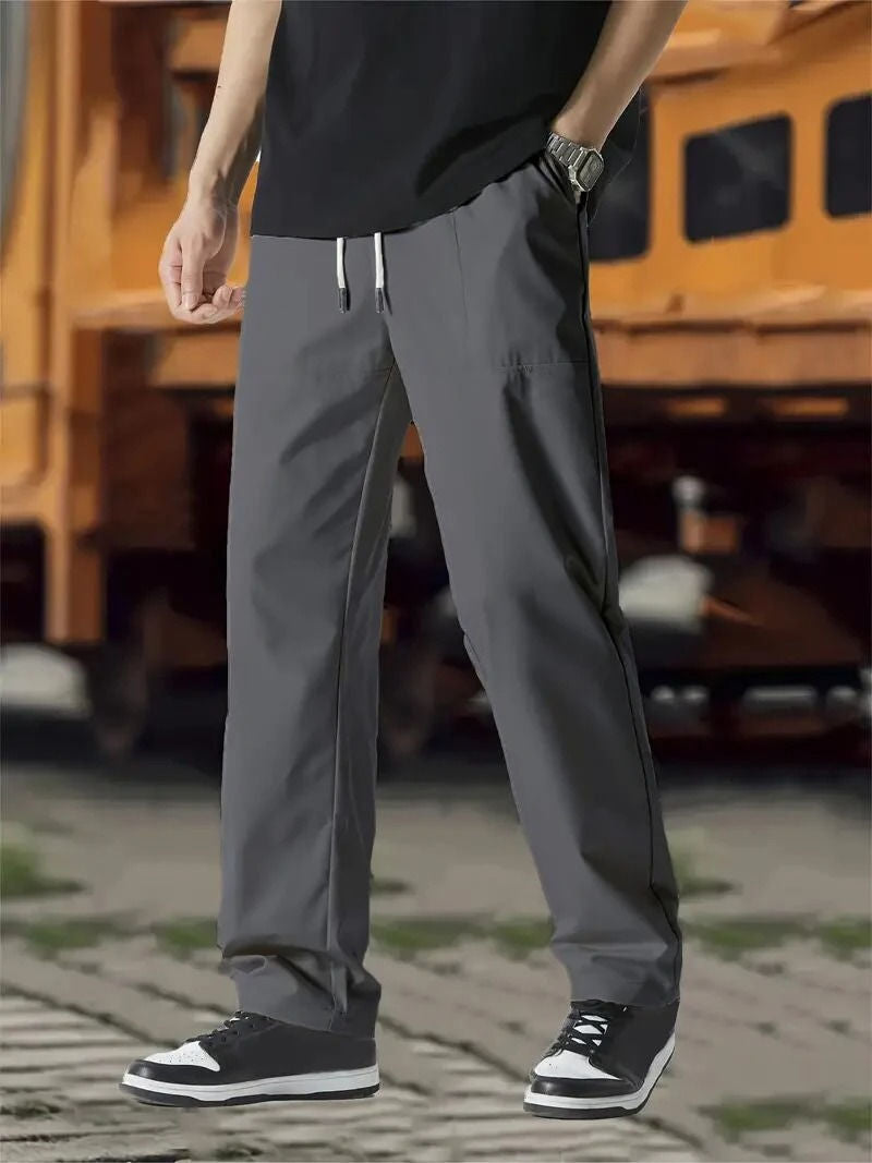 Men's gray modern-fit jogger track pants with elastic drawstring waist and flexible premium fabric