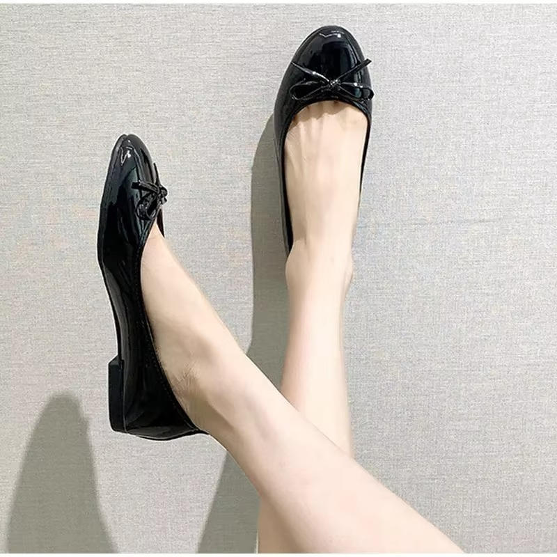 Black leather ballet flats with built-in arch support, polished professional style for all-day office comfort