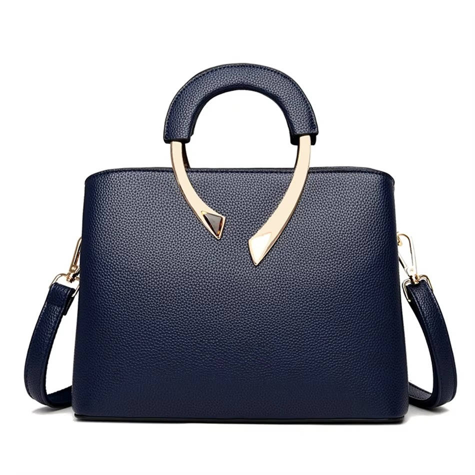 Structured pebbled faux leather handbag in neutral tone with polished gold metal handle, professional everyday style