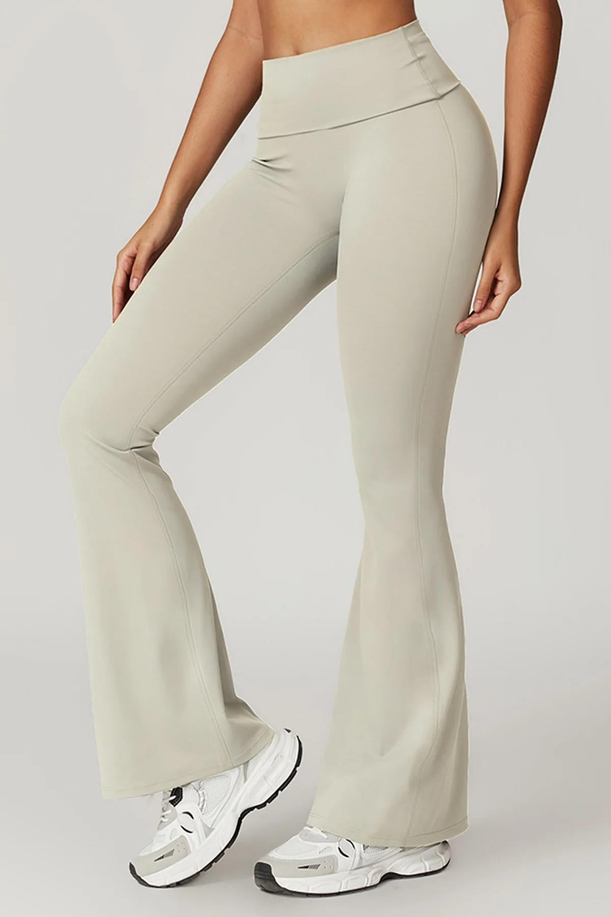 Women's black high-waisted yoga pants with tummy control panel, flattering slim fit silhouette