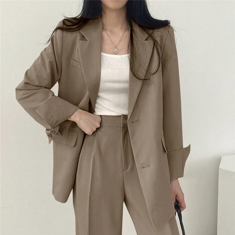 Women's tailored two-piece blazer suit in classic professional cut with sleek polished trousers
