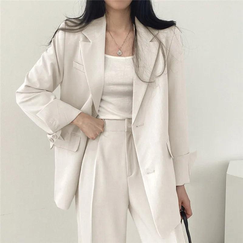 Women's tailored two-piece blazer suit in classic hue, slim-cut professional silhouette for chic officewear