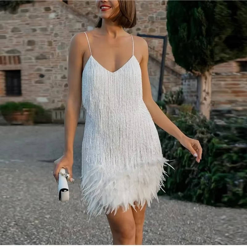 White sleeveless mini cocktail dress with fringe body and feather hem, body-conscious fit