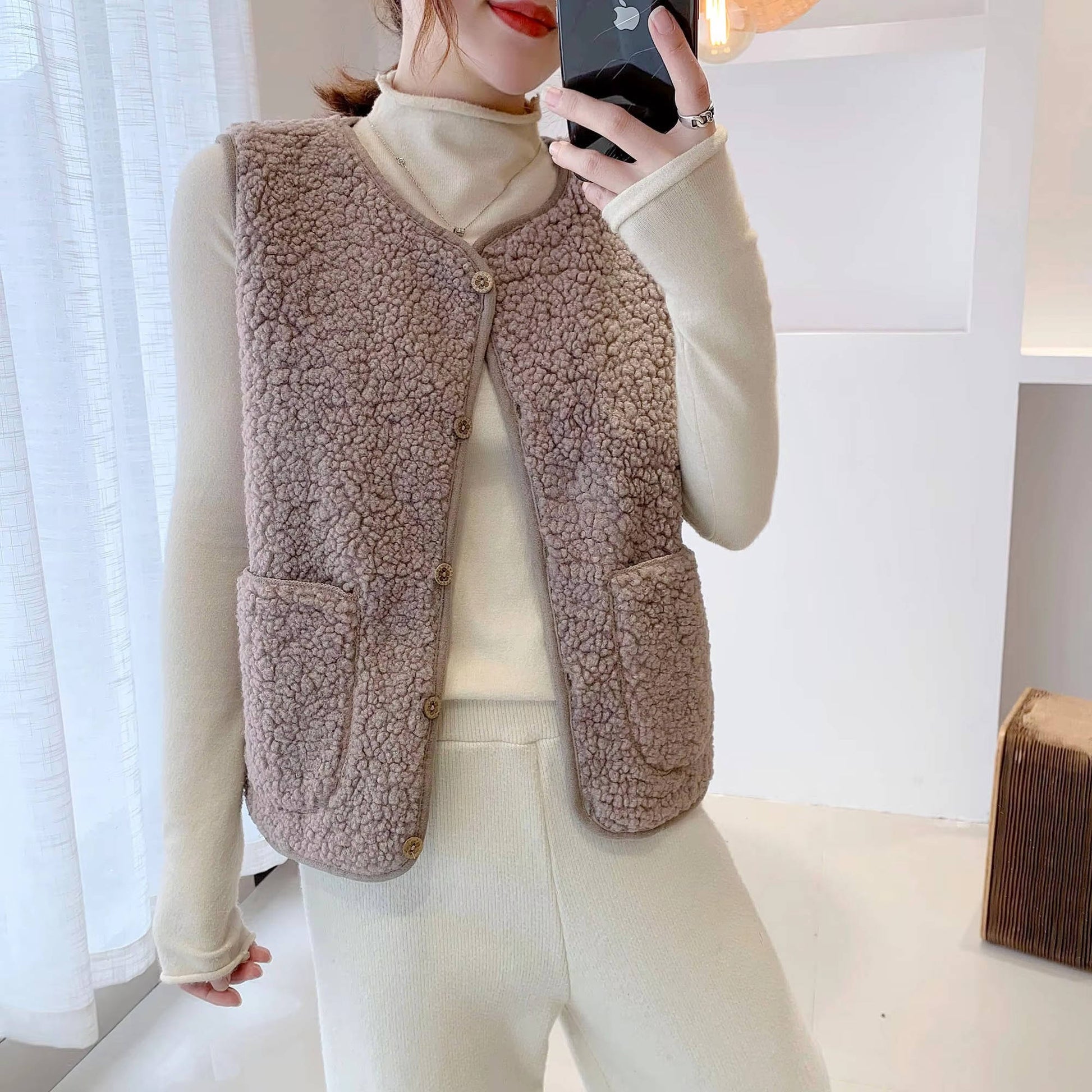 Women's cozy sherpa vest, plush fluffy fabric, sleeveless V-neck layering essential for everyday warmth