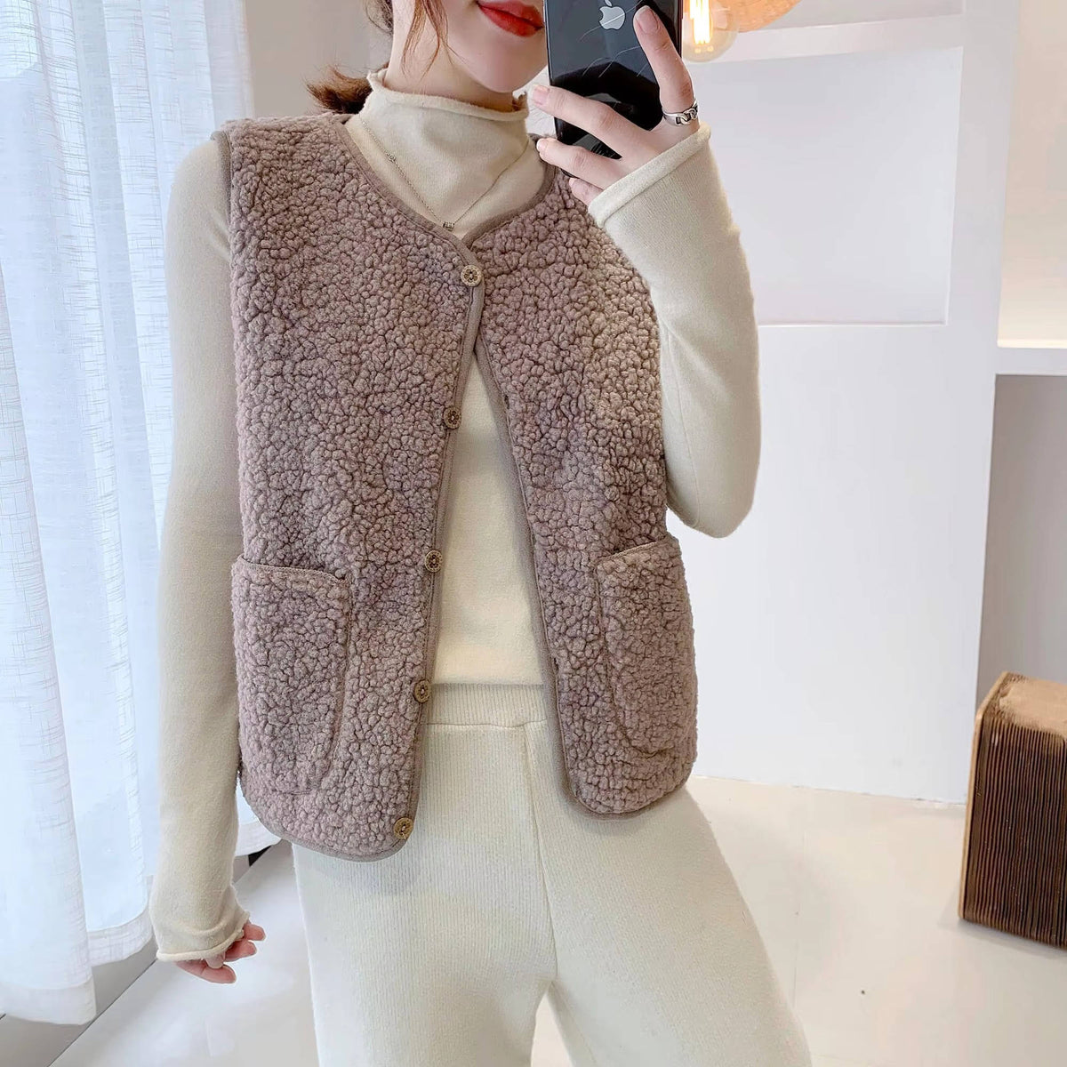 Women's cozy sherpa vest, plush fluffy fabric, sleeveless V-neck layering essential for everyday warmth