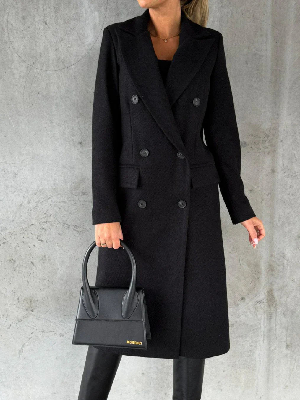 Charcoal double-breasted long coat notched collar front flap pockets tailored professional silhouette