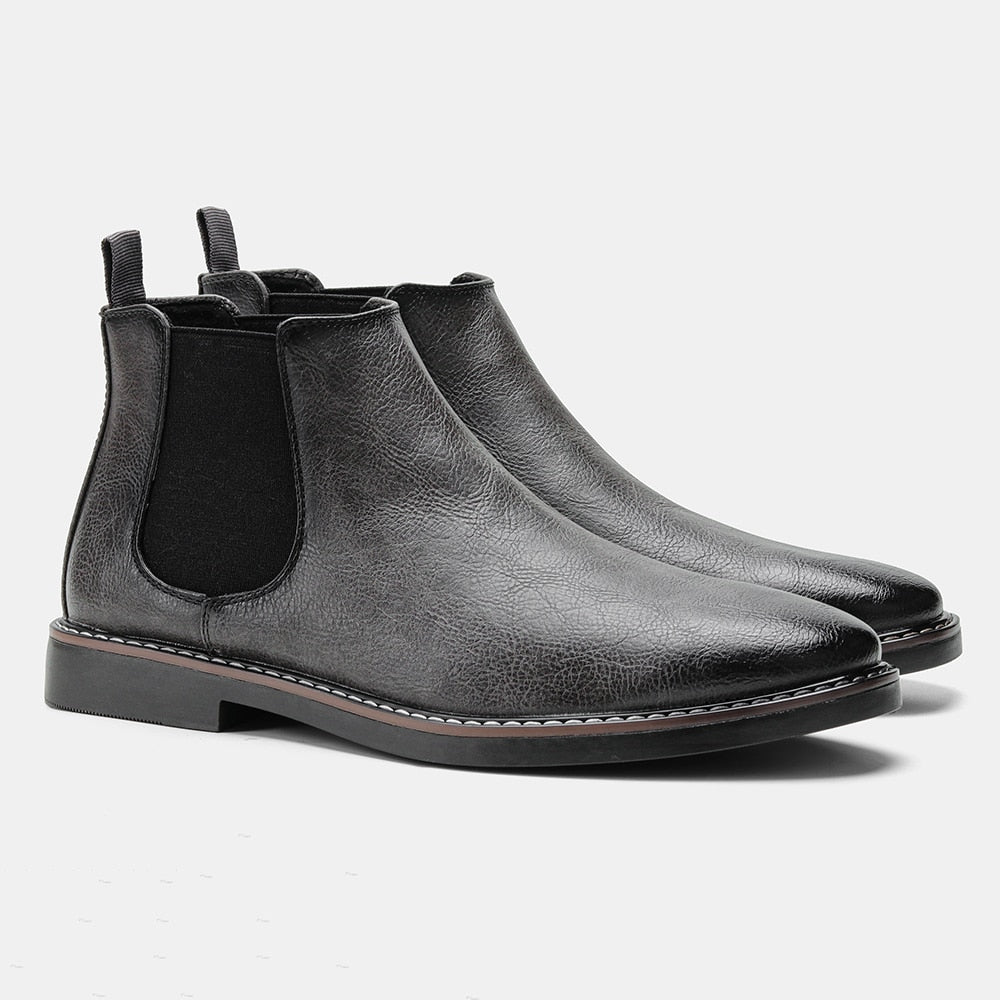 Men's black full-grain leather Chelsea boots with elastic side panels and sleek timeless silhouette