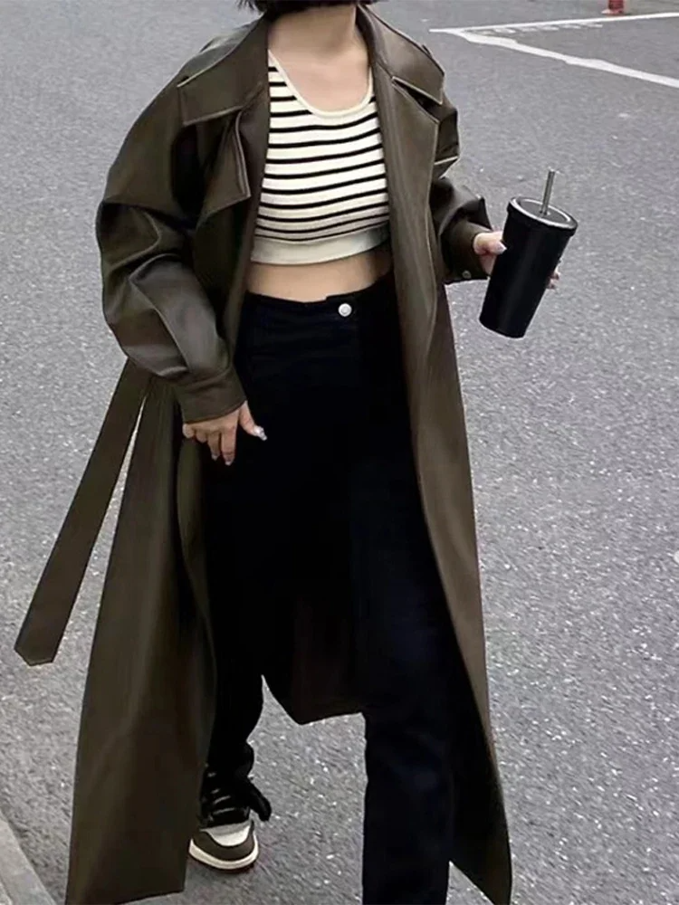 Women's black faux leather ankle-length tailored coat with classic lapel and sleek silhouette