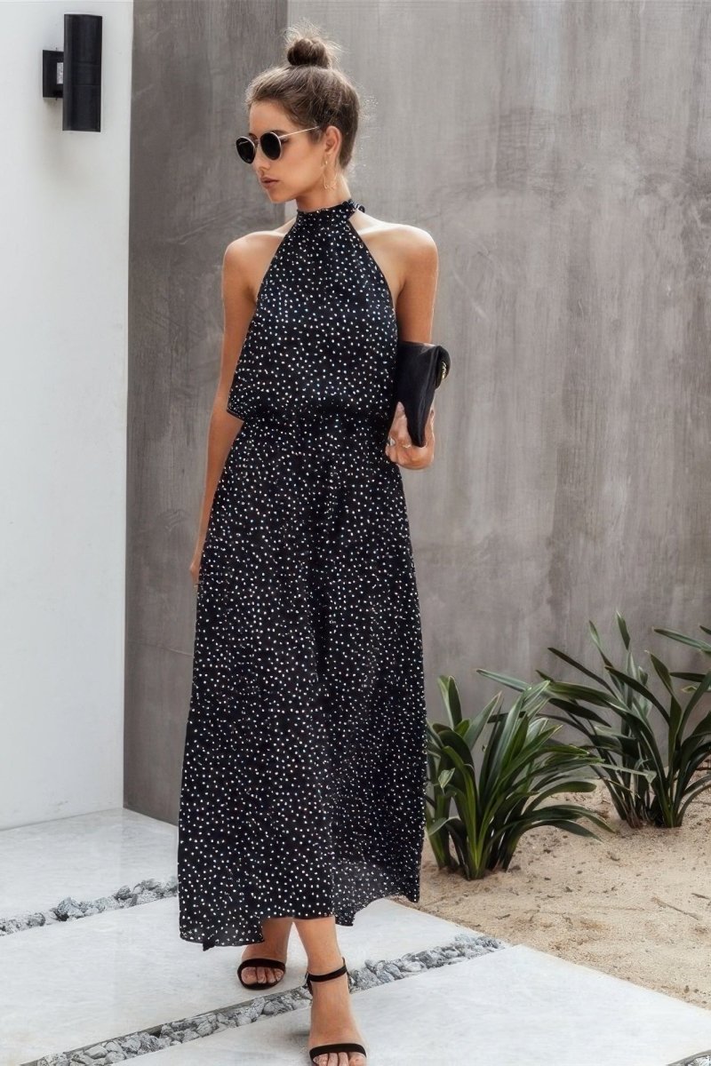 Black white polka dot halter neck midi dress with wrap neckline and flowy swing hem