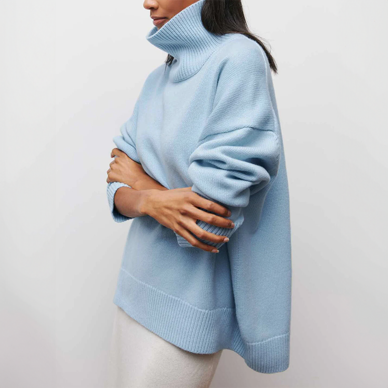 Women's oversized turtleneck knit sweater with draped silhouette and ribbed cuffs for layering