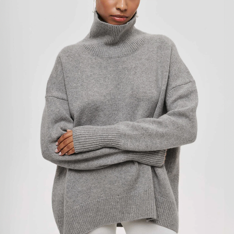 Women's oversized turtleneck knit sweater with draped silhouette and ribbed cuffs for effortless layering