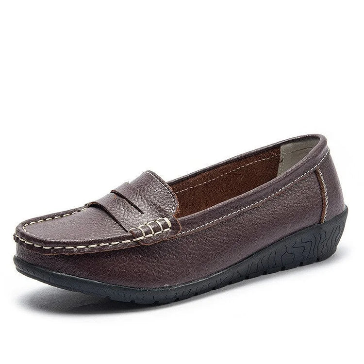 Women's black leather slip-on loafers with cushioned PU lining and flexible rubber sole for all-day comfort
