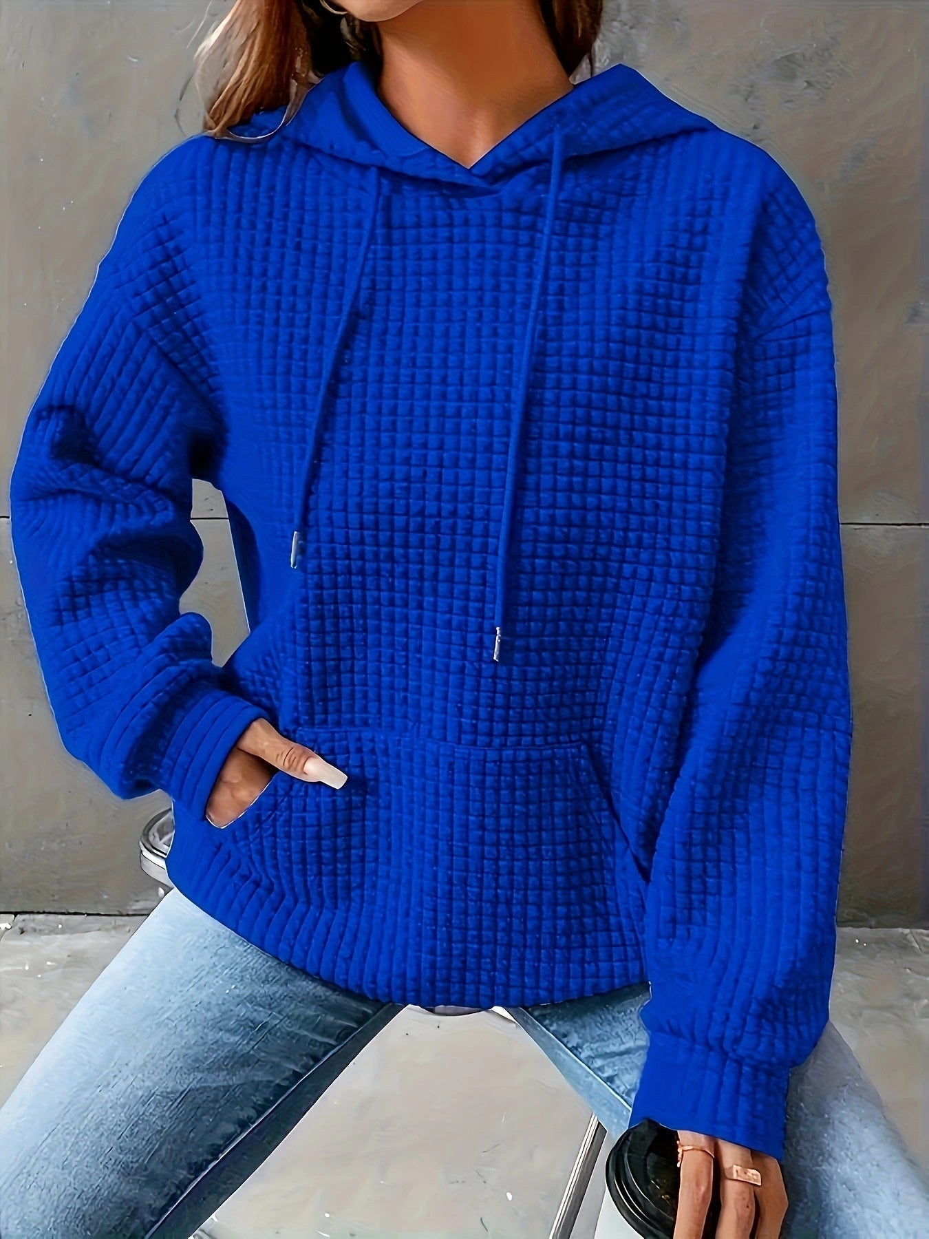 Women's loose fit hoodie with kangaroo pocket in soft textured fabric for casual everyday comfort
