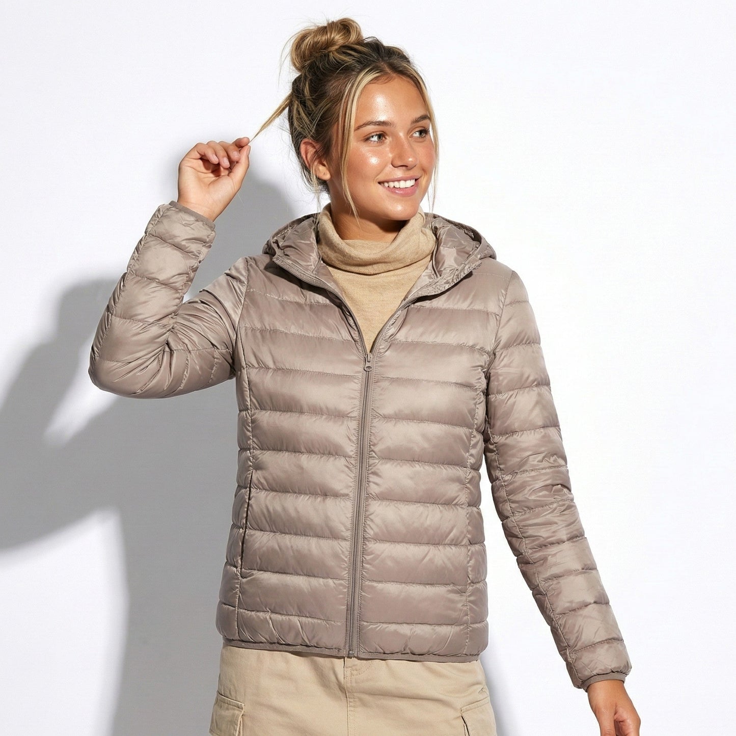 Women's lightweight hooded puffer jacket in chic silhouette with protective hood for everyday commutes