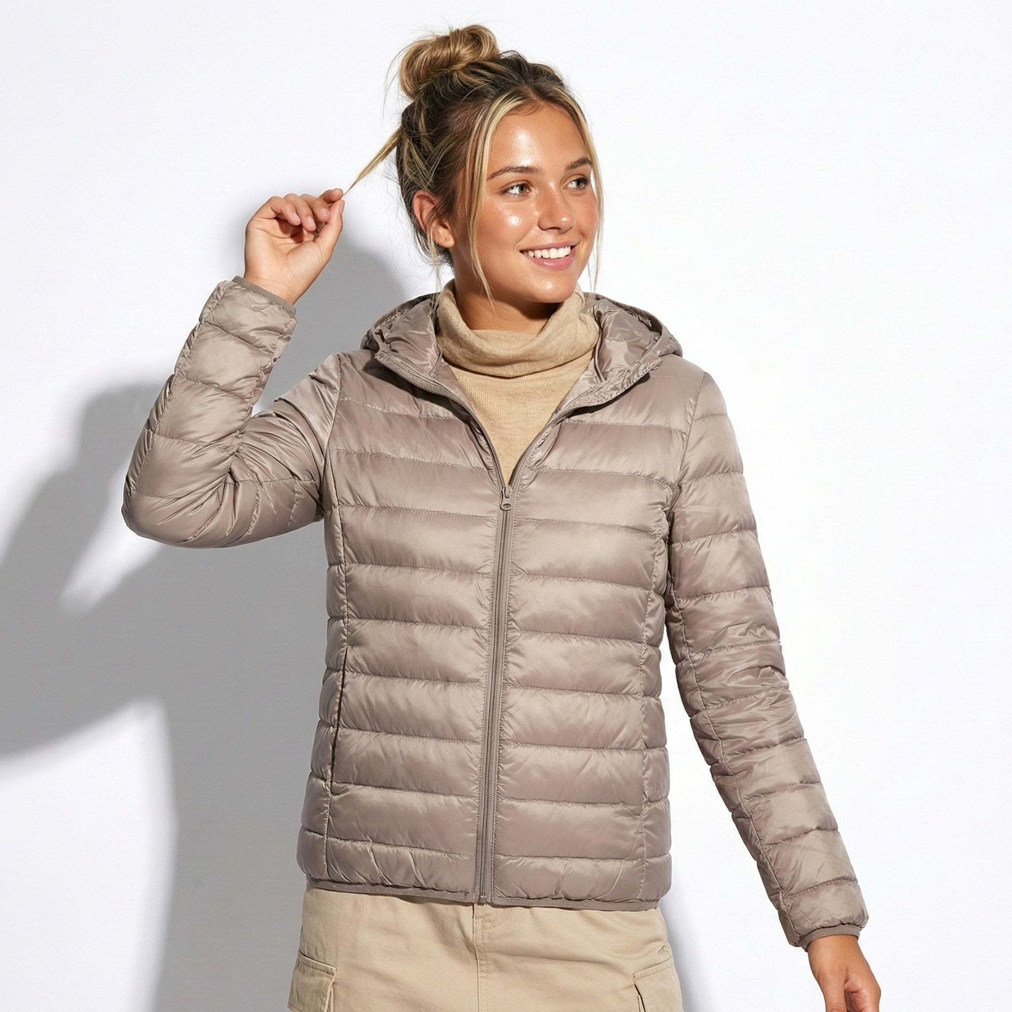 Women's lightweight hooded puffer jacket in chic silhouette with protective hood for everyday commutes