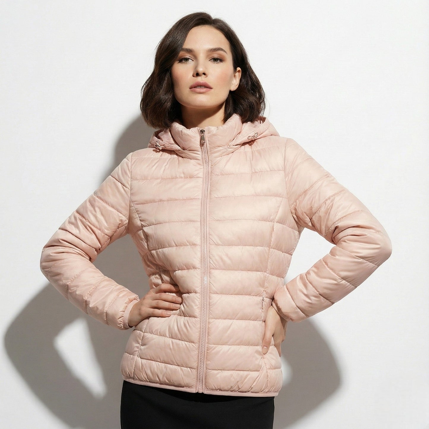 Women's lightweight hooded puffer jacket sleek silhouette in neutral tone packable cold-weather layer