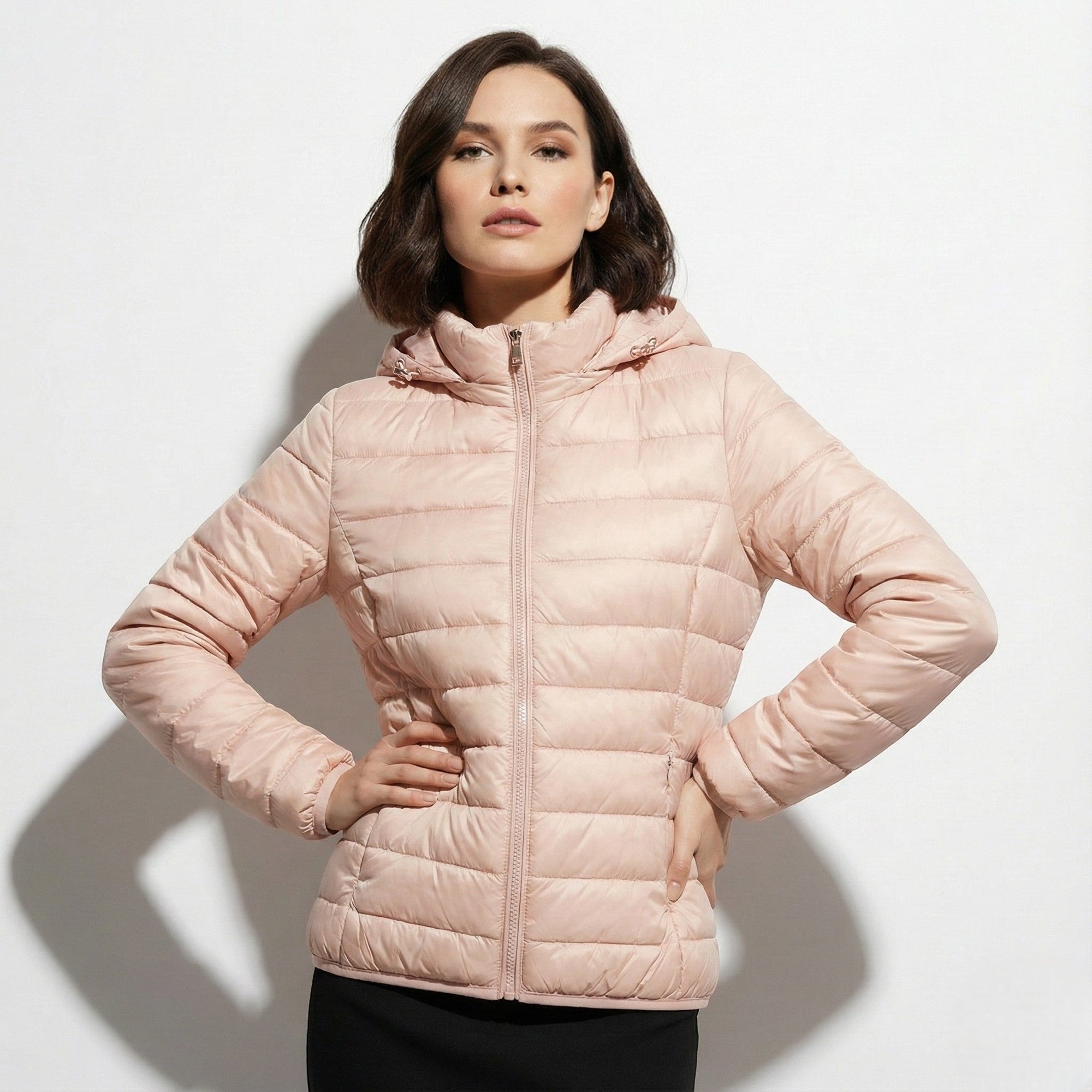 Women's lightweight hooded puffer jacket sleek silhouette in neutral tone packable cold-weather layer